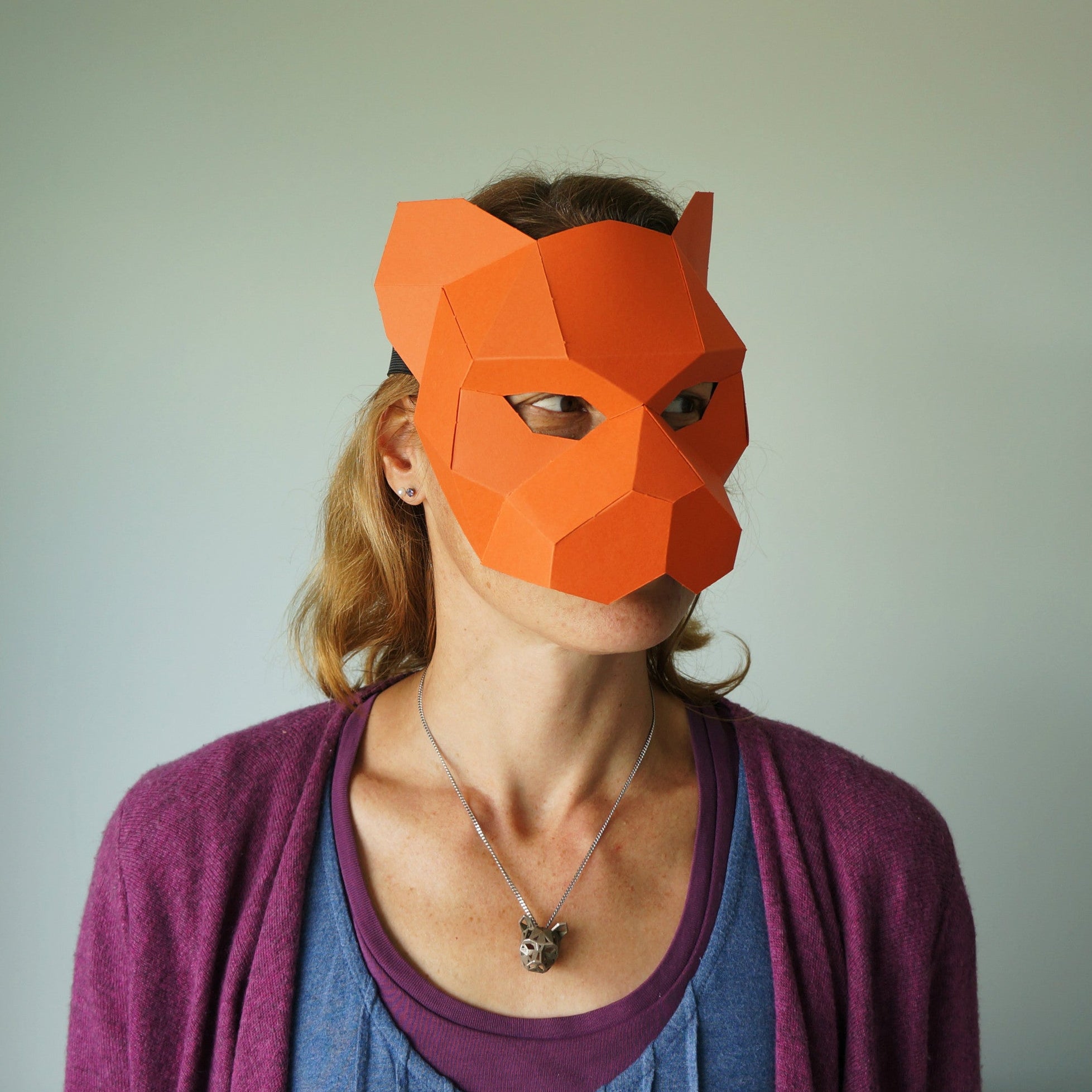 women wearing a paper tiger mask