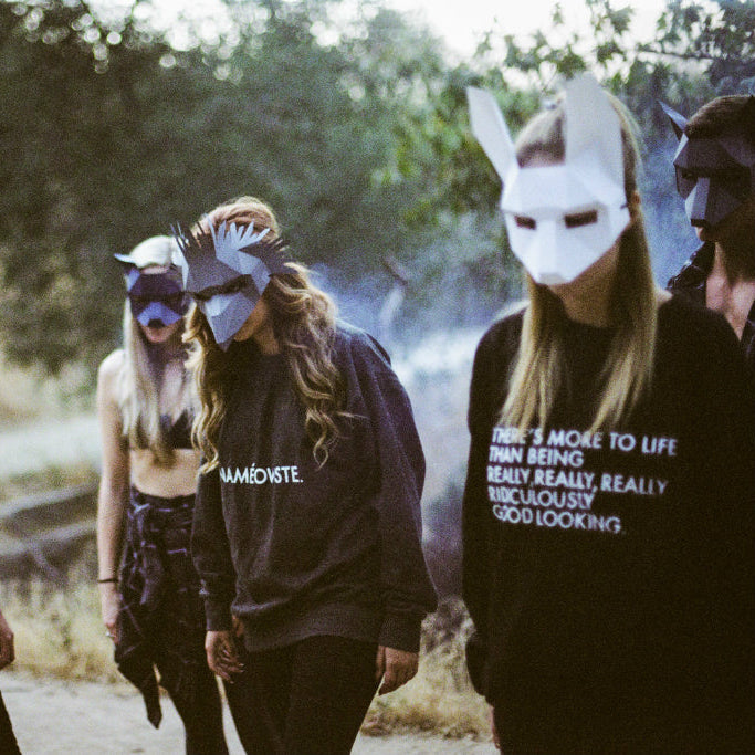 A group of people wearing wintercroft animal masks and hoodies outdoors